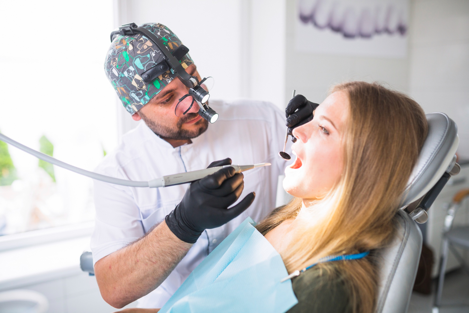 Dentist examining a patient’s teeth during a dental checkup in a modern dental office.