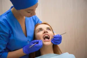 Dentist examining patient during gum surgery in Brandywine, MD for periodontal treatment.