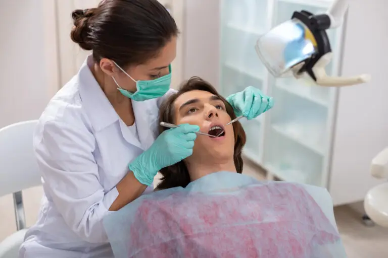 Periodontist examining a patient’s mouth during an oral biopsy and gum disease examination in Brandywine, MD