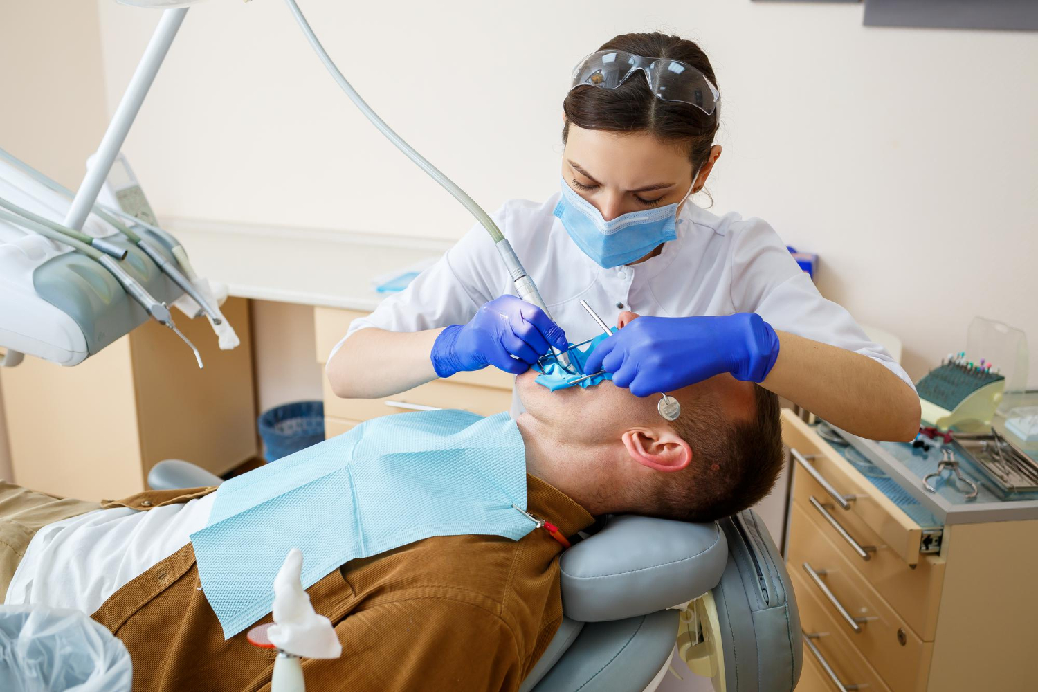 Dentist performing deep dental cleaning treatment on a patient during a periodontal procedure.