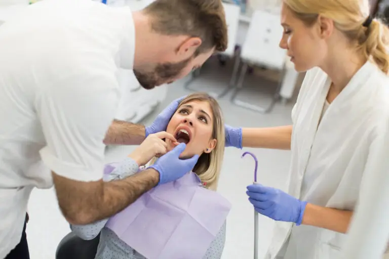 Dentist examining a patient’s mouth for a mouth lesion before an oral biopsy and dental evaluation in Brandywine, MD.
