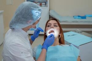 Periodontist performing flap surgery for gum disease in Brandywine, MD during a dental treatment appointment for patient.